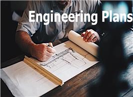 A man working on blueprints to illustrate article about engineering plans
